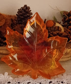 Handmade translucent resin maple leaf trinket dish in orange, red and golden autumn colors