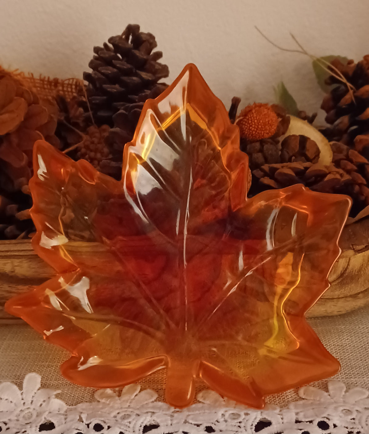Handmade translucent resin maple leaf trinket dish in orange, red and golden autumn colors