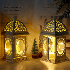 Pair of vintage-style metal lanterns with decorative cutout panels and glowing LED fairy lights, displayed among seasonal decorations.