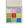 Open metallic watercolor palette showing nine pearlescent paint colors arranged in a compact case
