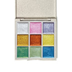 Open metallic watercolor palette showing nine pearlescent paint colors arranged in a compact case