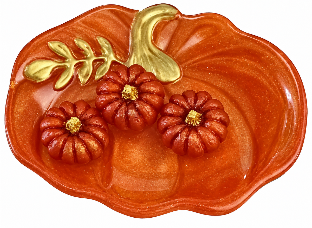 Handmade orange resin pumpkin trinket dish with gold stem and leaf detailing, accompanied by three matching miniature resin pumpkins.