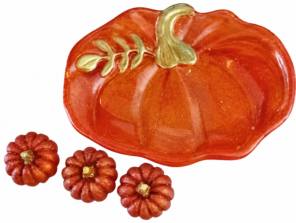 Handmade orange resin pumpkin trinket dish with gold stem and leaf detailing, accompanied by three matching miniature resin pumpkins.