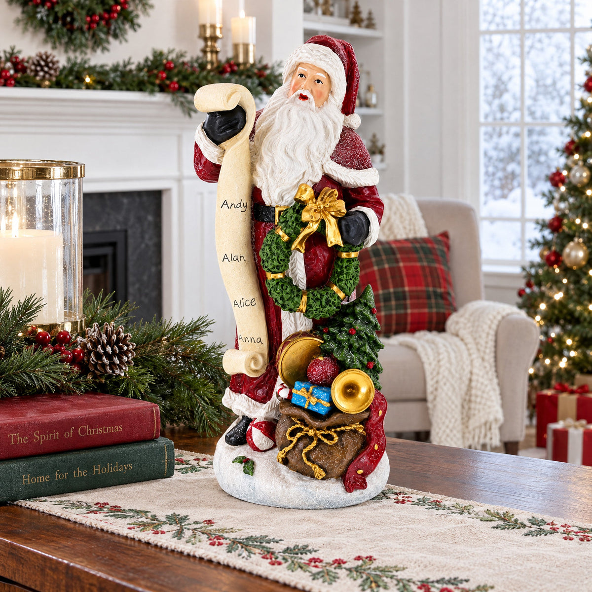 A Santa Claus holiday figurine stands on a table in a decorated living room. The Santa figure holds a scroll with names and carries a sack of ornaments, wrapped gifts, and a small tree.