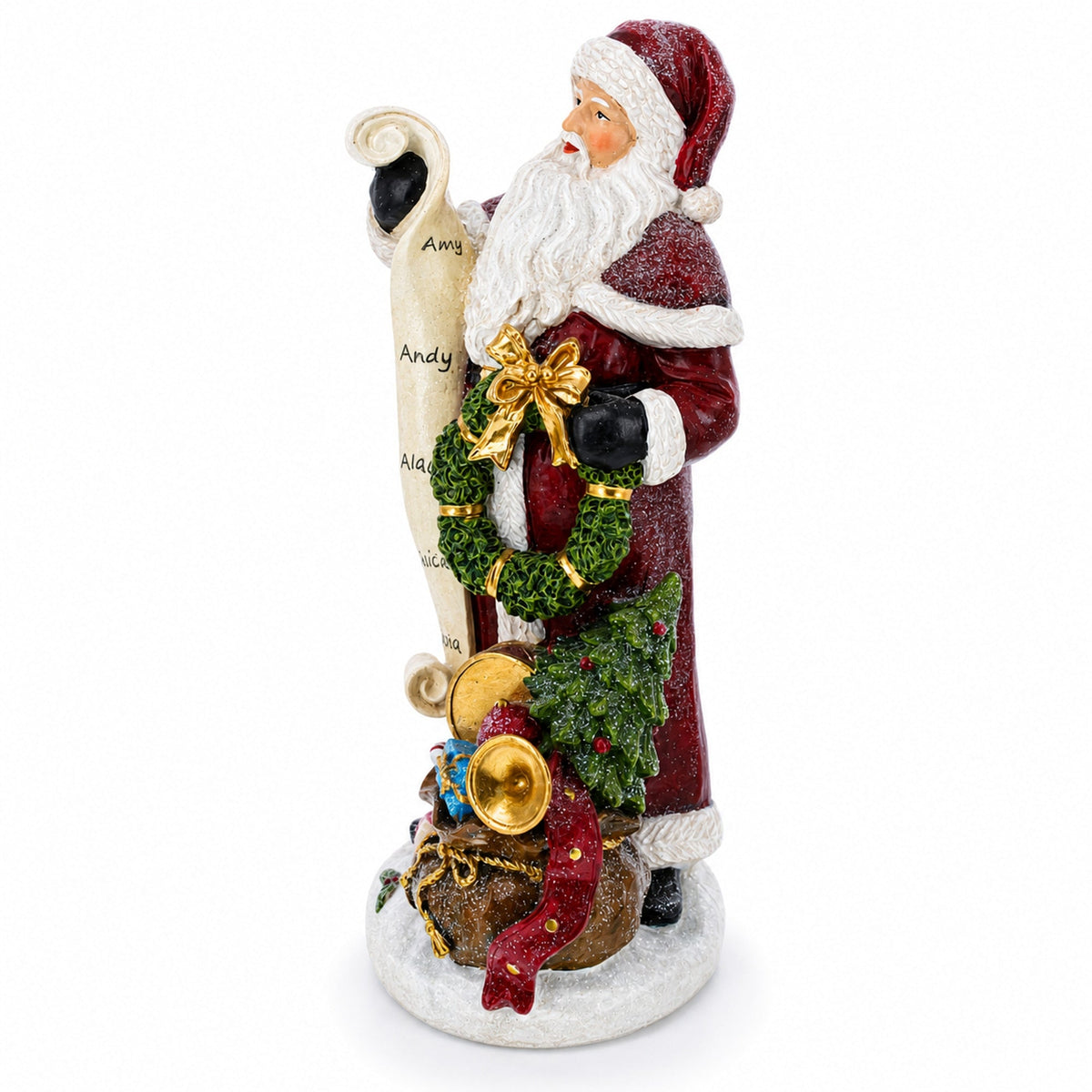 A Santa Claus holiday figurine holding a scroll with names, decorated with a green wreath, gold bow, and a sack of gifts, set against a plain white background.