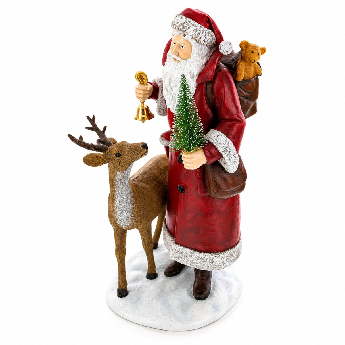 A Santa Claus figurine wearing a red coat with silver trim, holding a small Christmas tree and a gold bell, standing beside a brown reindeer on a white base. Santa has a brown teddy bear on his back, and the figurine is photographed against a plain white background.