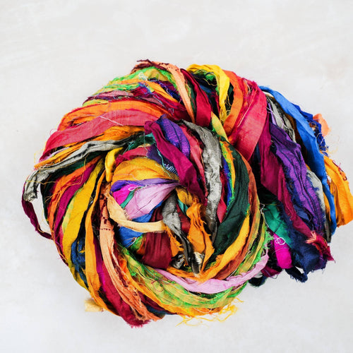 At the Bahamas recycled sari silk ribbon showing varied jewel-tone strips and naturally frayed edges