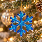 Reverse side of handmade translucent blue resin snowflake ornament showing glossy blue resin and clear edges on white background.