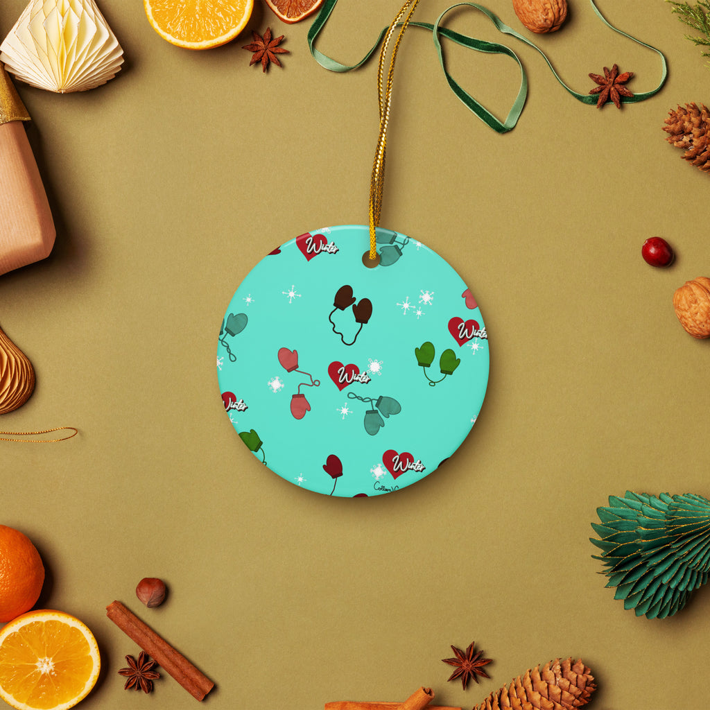 Vintage-inspired ceramic Christmas ornament with colorful children’s mittens on an aqua background