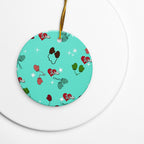 Vintage-inspired ceramic Christmas ornament with colorful children’s mittens on an aqua background