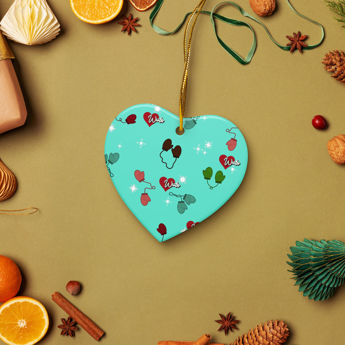 Vintage-inspired ceramic Christmas ornament with colorful children’s mittens on an aqua background