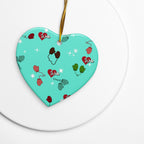 Vintage-inspired ceramic Christmas ornament with colorful children’s mittens on an aqua background