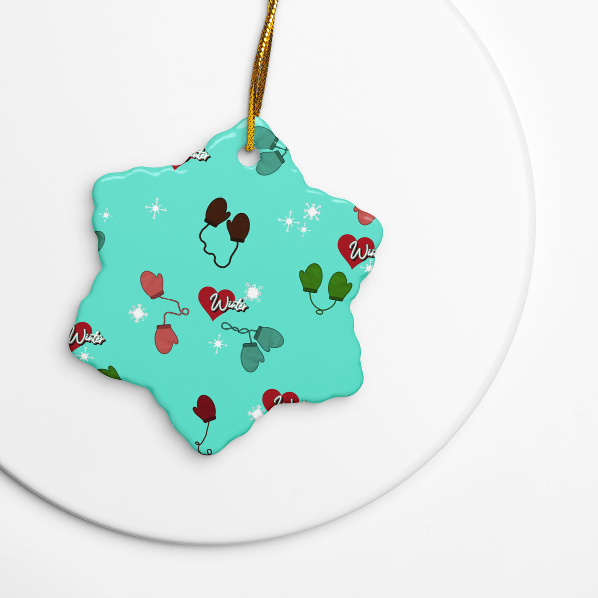 Vintage-inspired ceramic Christmas ornament with colorful children’s mittens on an aqua background