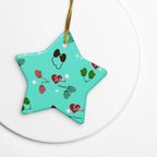 Vintage-inspired ceramic Christmas ornament with colorful children’s mittens on an aqua background