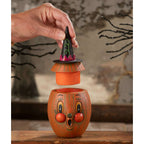 Hand lifting the witch hat from the Gourdy Orange-O-Ween Halloween decoration.