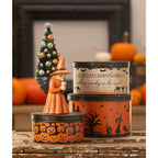 Bethany Lowe Halloween nesting tins arranged with pumpkins and other autumn decorations.