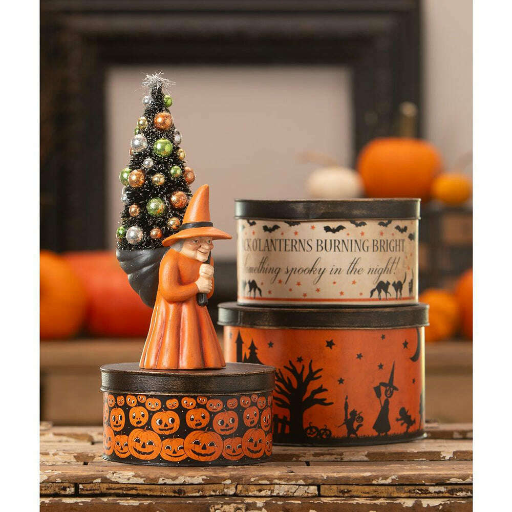 Bethany Lowe Halloween nesting tins arranged with pumpkins and other autumn decorations.
