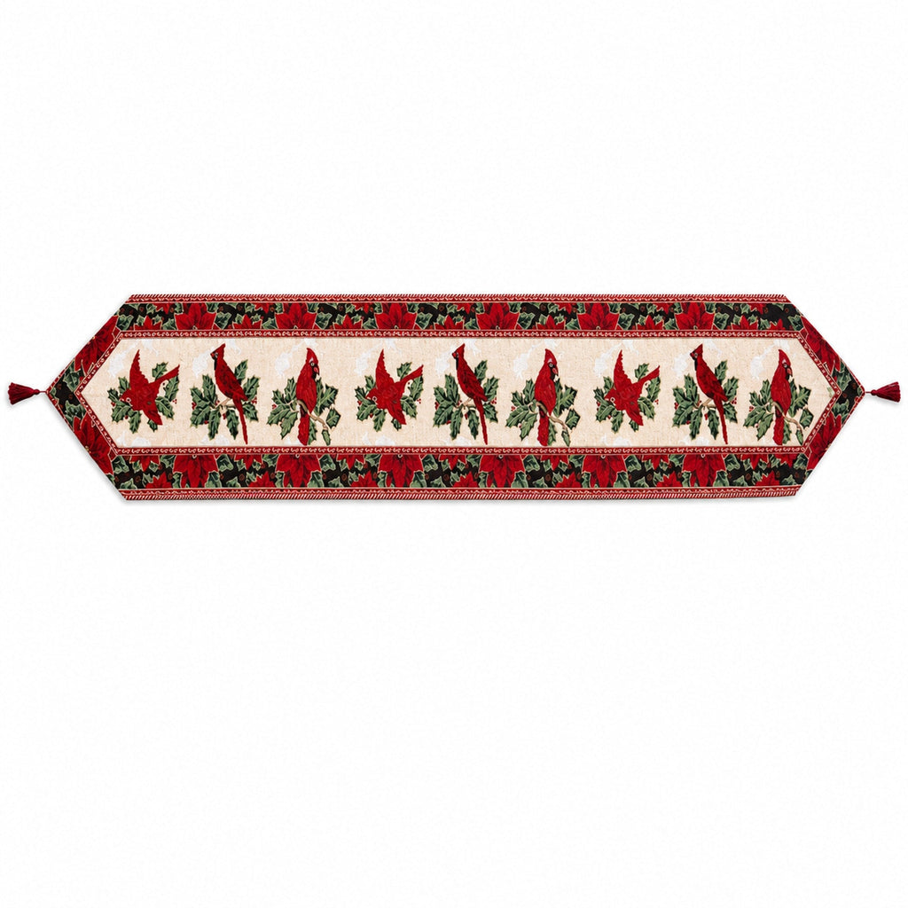 A festive table runner with a red and green holiday pattern featuring cardinal birds, holly leaves, and roses on a cream background, finished with red tassels on both ends.