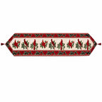 A festive table runner with a red and green holiday pattern featuring cardinal birds, holly leaves, and roses on a cream background, finished with red tassels on both ends.