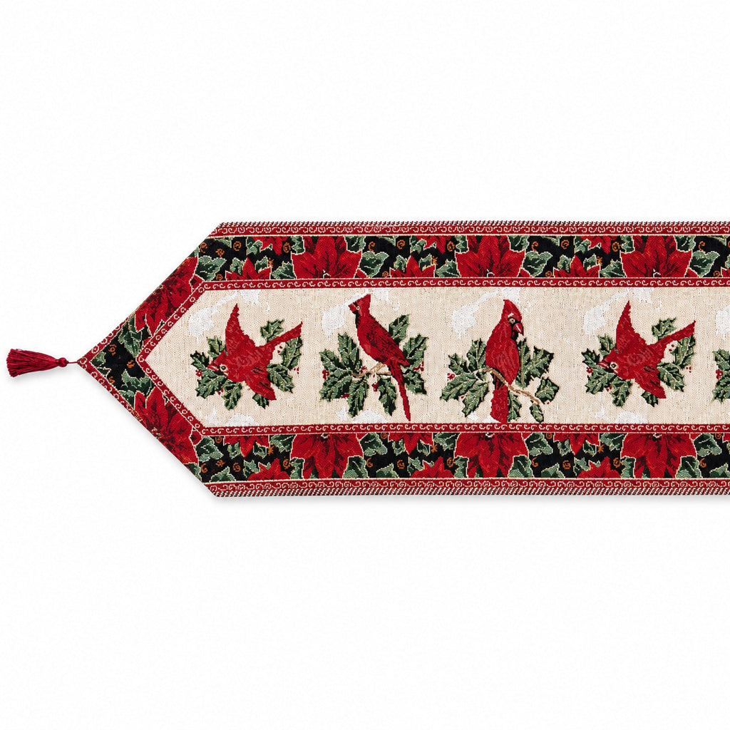 A festive Christmas table runner with a cream center panel featuring red cardinals and green holly leaves, bordered by red poinsettias and green foliage on a white background.