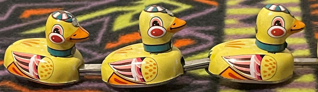 Vintage tin wind-up duck family toy shown from another angle