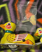 Close-up of the wind-up mechanism on the vintage tin duck toy, if shown