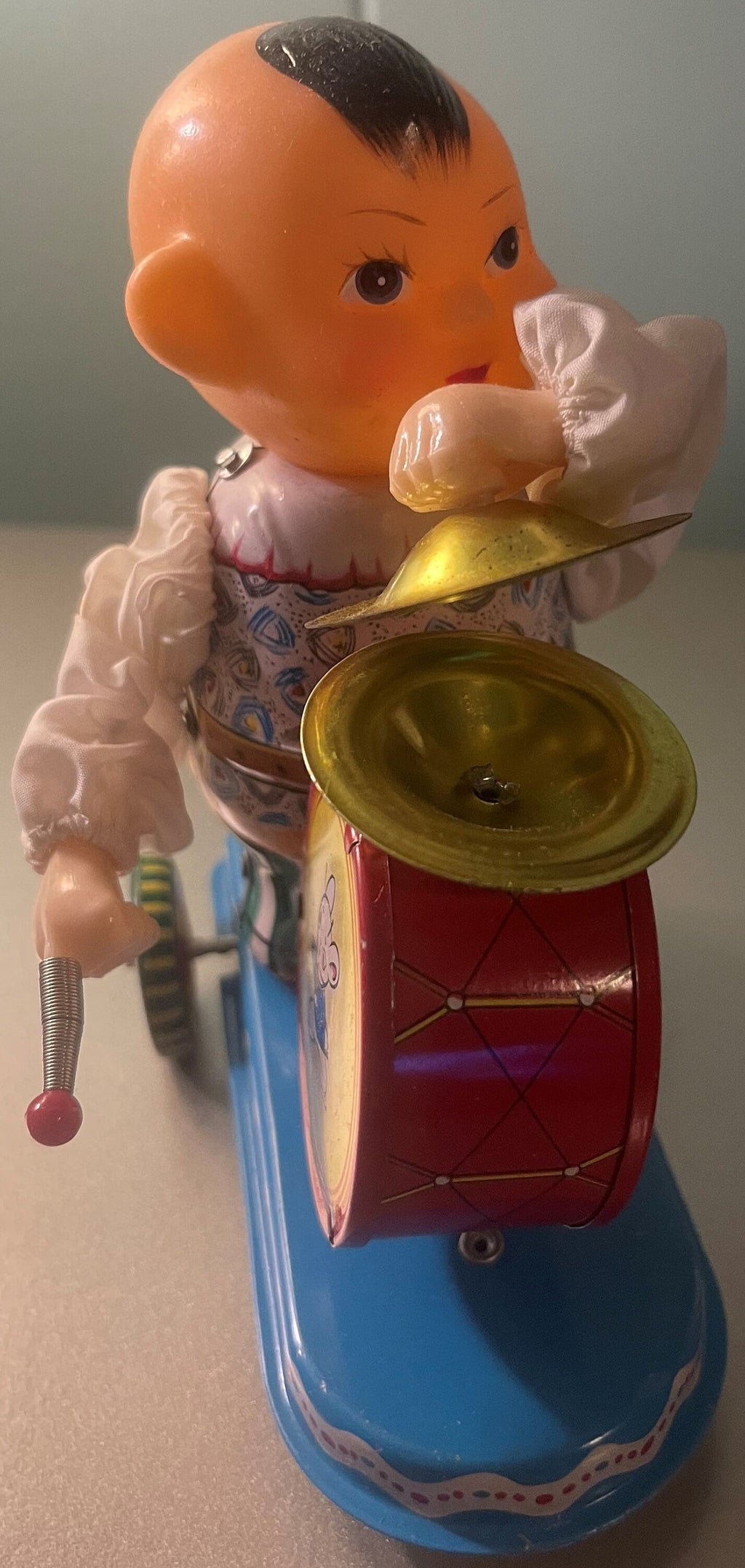 Side view of the vintage tin boy drummer holding his drum