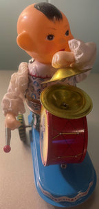 Side view of the vintage tin boy drummer holding his drum