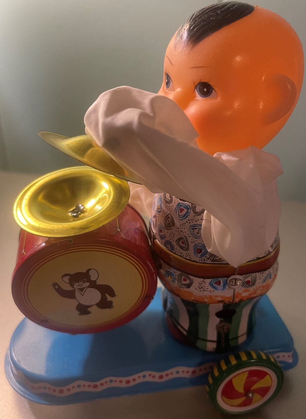 Vintage tin boy drummer wind-up toy with colorful painted details and a small drum