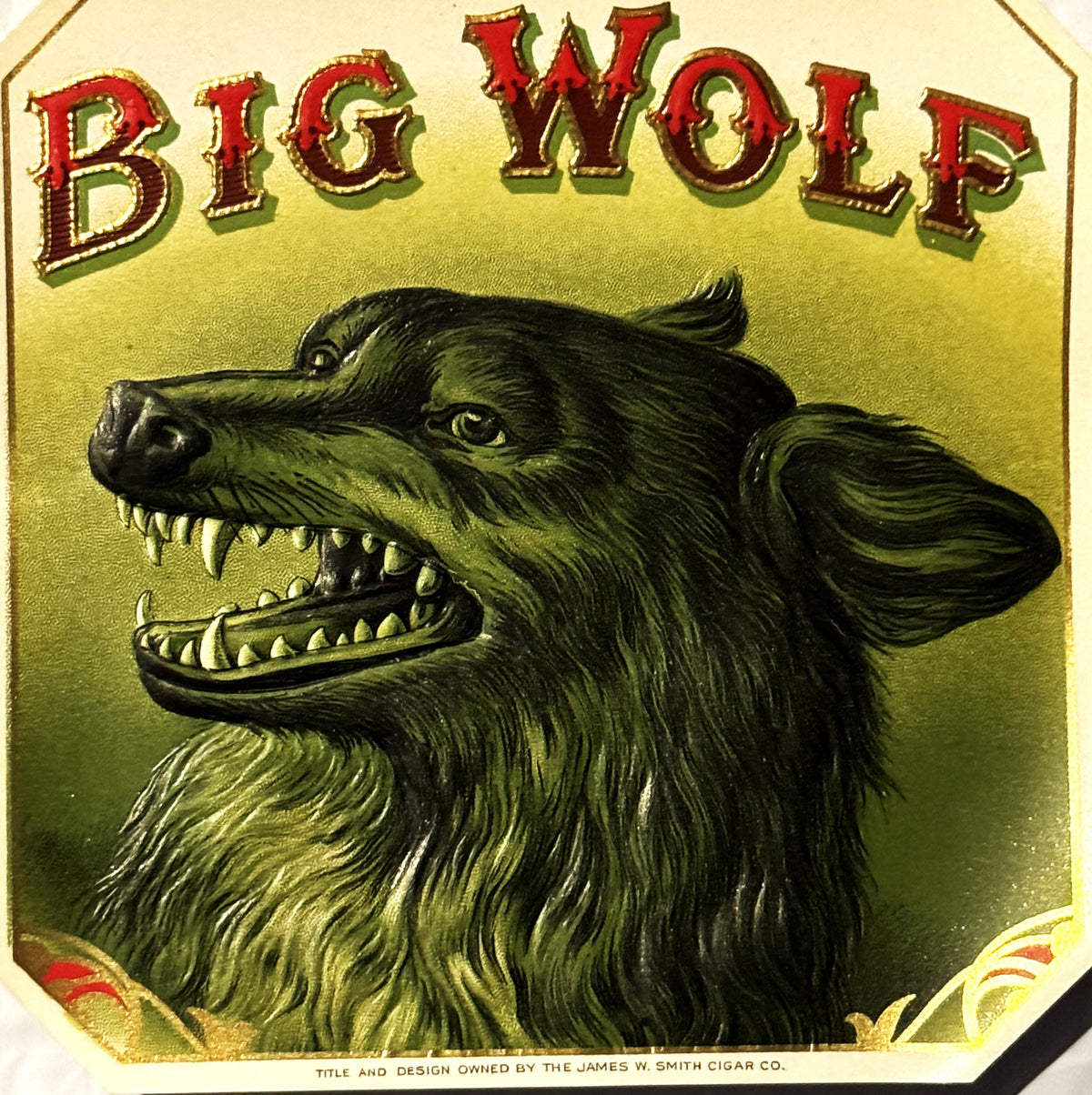 Antique Big Wolf cigar label with black wolf illustration and gold embossed details