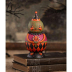 Jackie Green-O-Ween Spooks Jar displayed on stacked books, showing its vintage-inspired Halloween design.