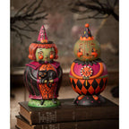 Two whimsical Johanna Parker Halloween collectibles displayed together on a rustic shelf.
