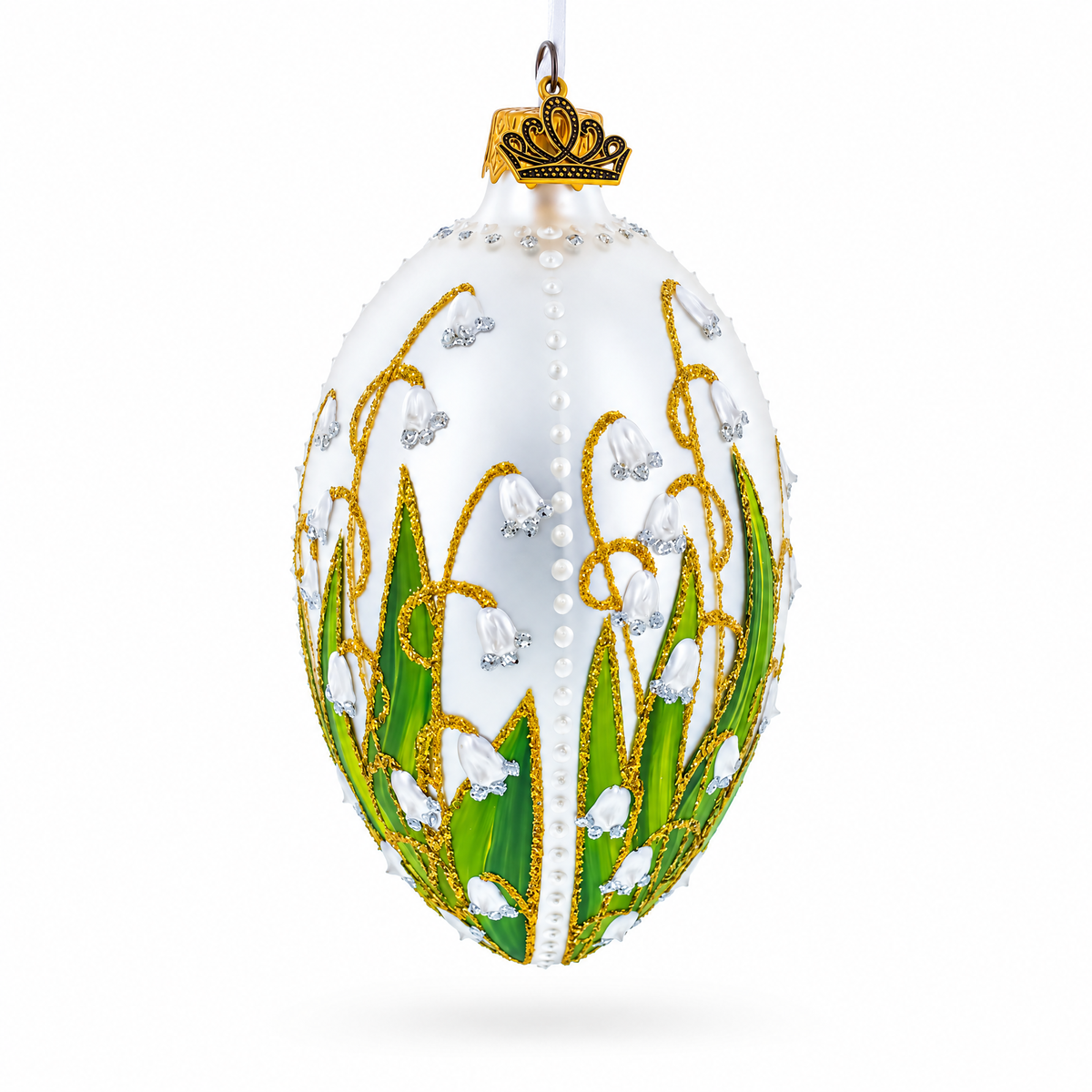 Back view of lily of the valley glass egg ornament with green leaves, white flowers, pearl accents and gold detailing
