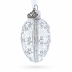 Side view of clear winter glass egg ornament with silver-toned details