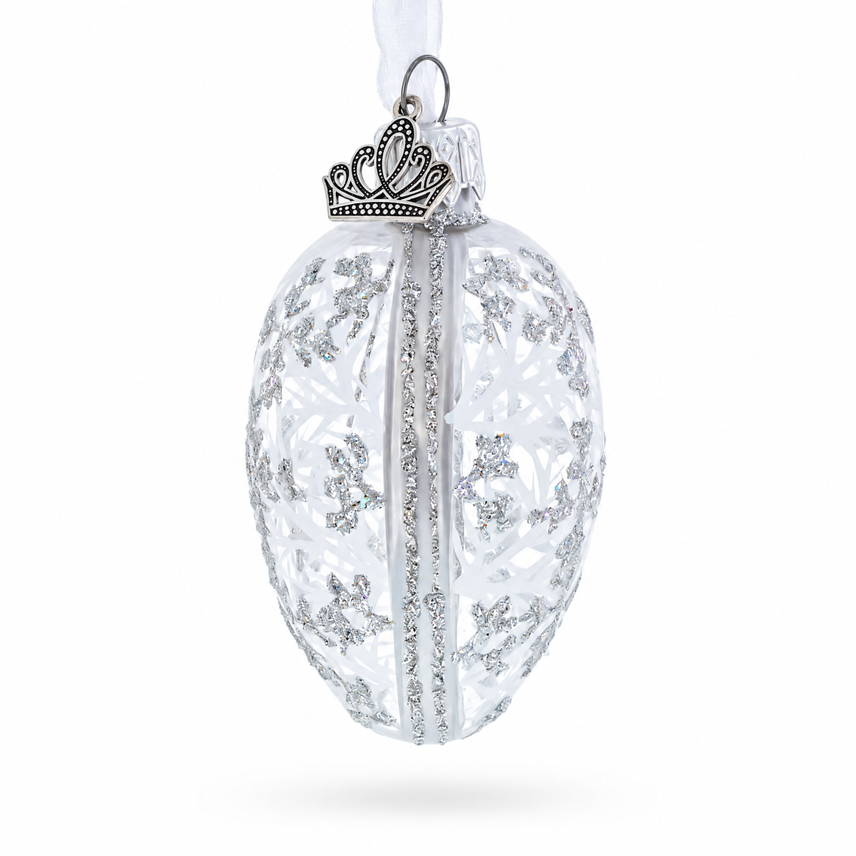 Side view of clear winter glass egg ornament with silver-toned details