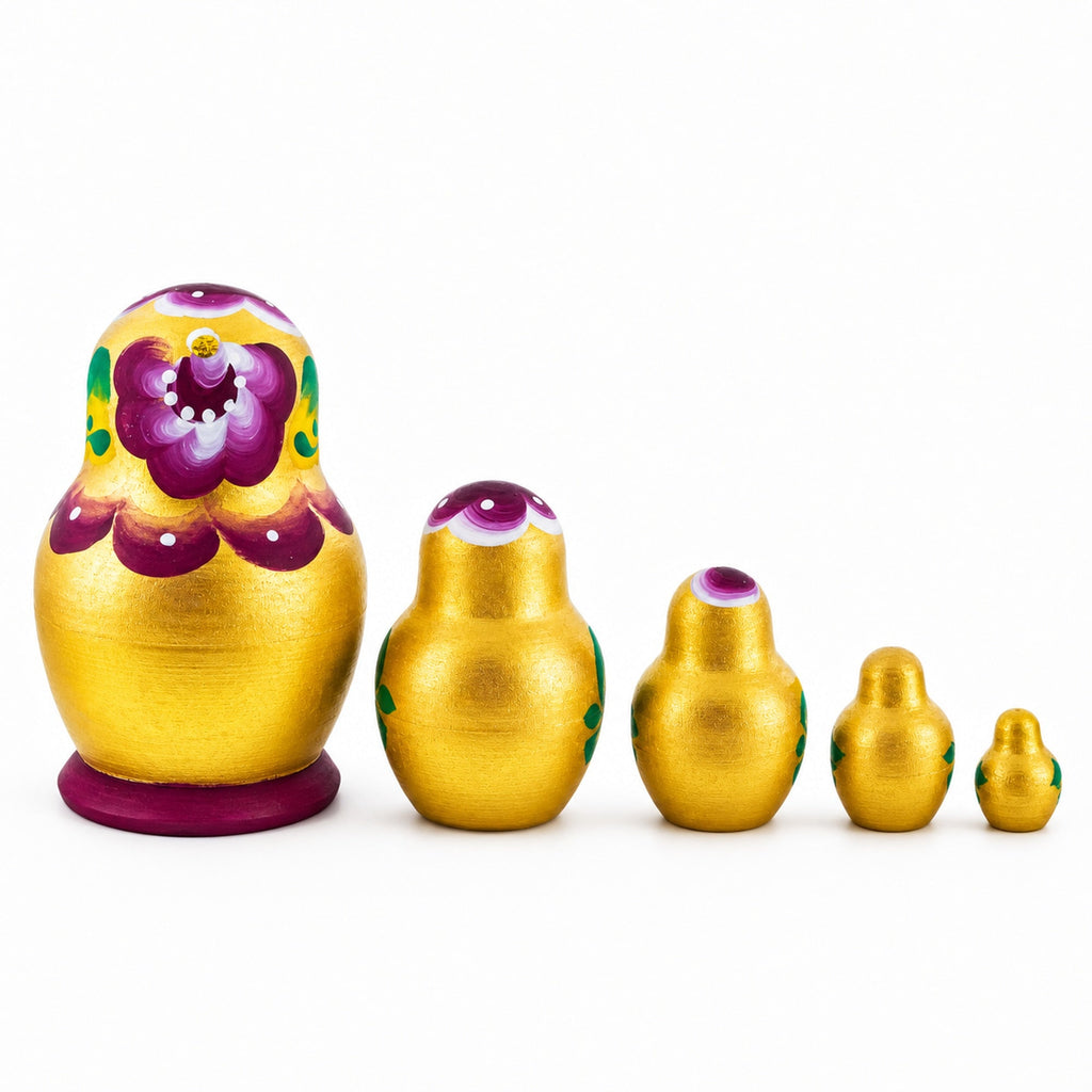 Back view of gold and violet wooden nesting dolls, set of five