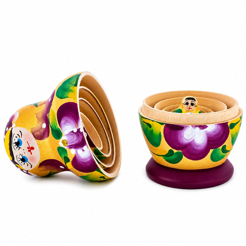 Open gold and violet wooden nesting dolls showing how the five pieces nest inside one another
