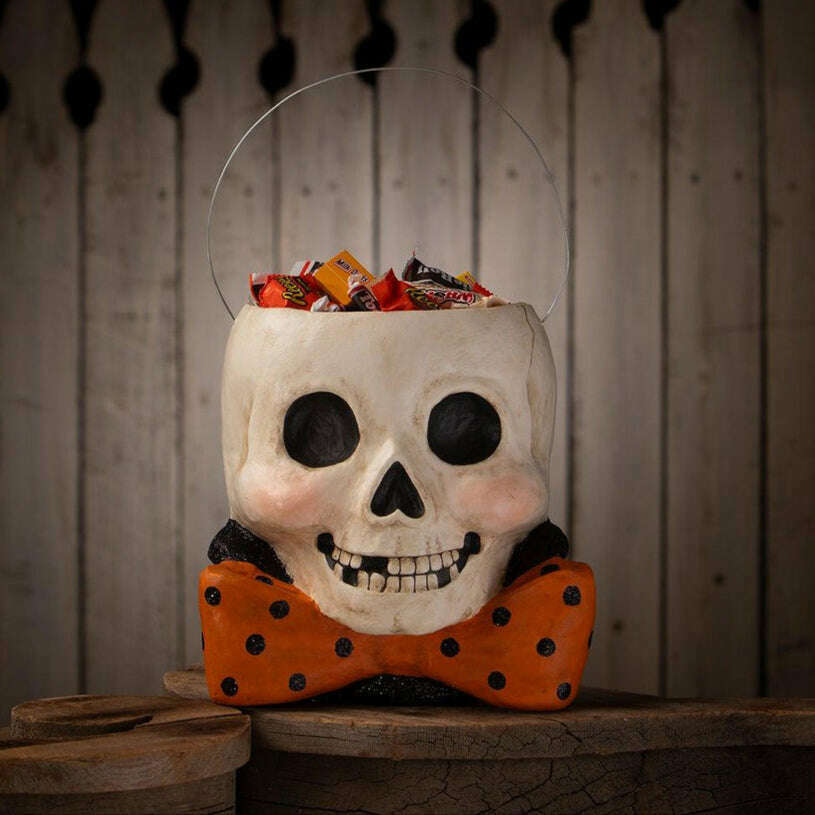 Side view of Mr. Albert Skully Halloween bucket showing the skull shape and oversized orange bow tie.