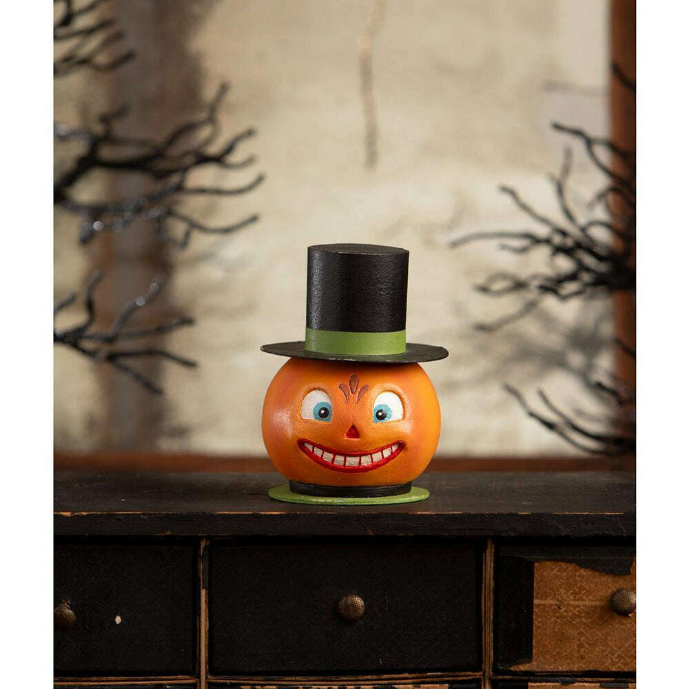 Smiling Pumpkin Container displayed on a dark wooden cabinet with vintage-inspired Halloween decorations.