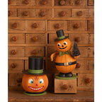 Smiling Pumpkin Container displayed beside another vintage-inspired Halloween pumpkin decoration.