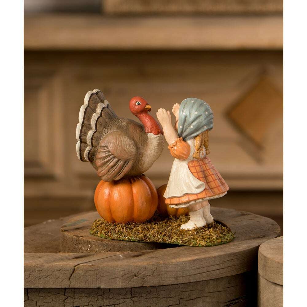 Trudy with Turkey figurine displayed on a rustic wooden surface, showing its vintage-inspired autumn colors and mossy base.
