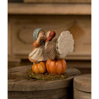 Side view of Trudy with Turkey by Bethany Lowe Designs, showing the girl reaching toward the turkey perched on a pumpkin.