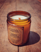 Vintage Parlour Cabin Sunrise wooden wick candle in an amber glass jar on a rustic wooden surface