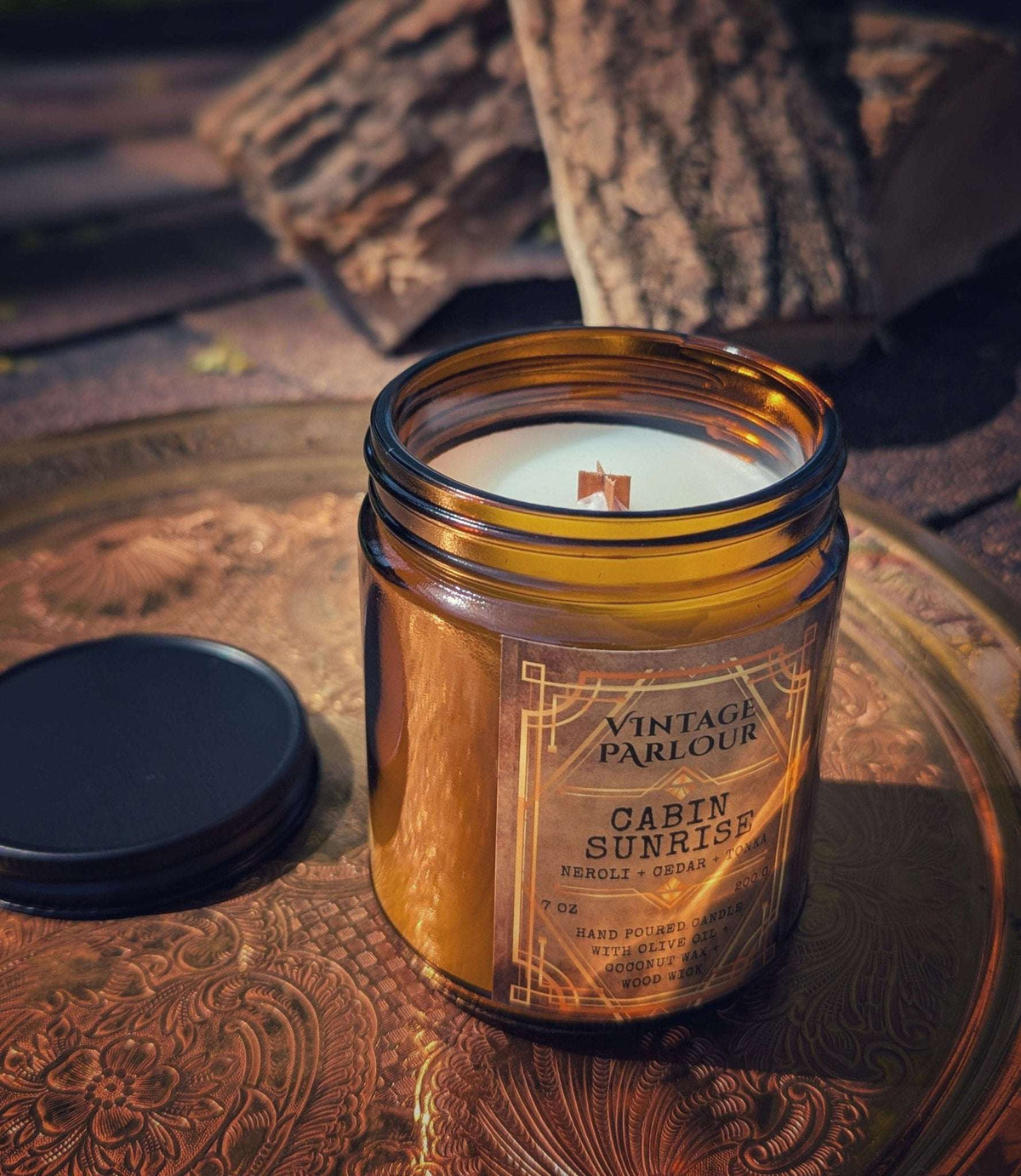 Vintage Parlour Cabin Sunrise wooden wick candle in an amber glass jar styled with rustic wood and an ornate tray