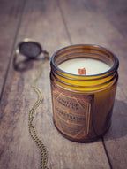Vintage Parlour Pocketwatch wooden wick candle in an amber glass jar on rustic wood with an antique pocket watch and chain