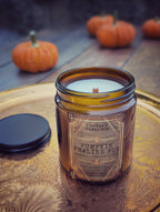 Vintage Parlour Pumpkin Praline Pie wooden wick candle in an amber glass jar displayed on an ornate vintage tray with small pumpkins in the background