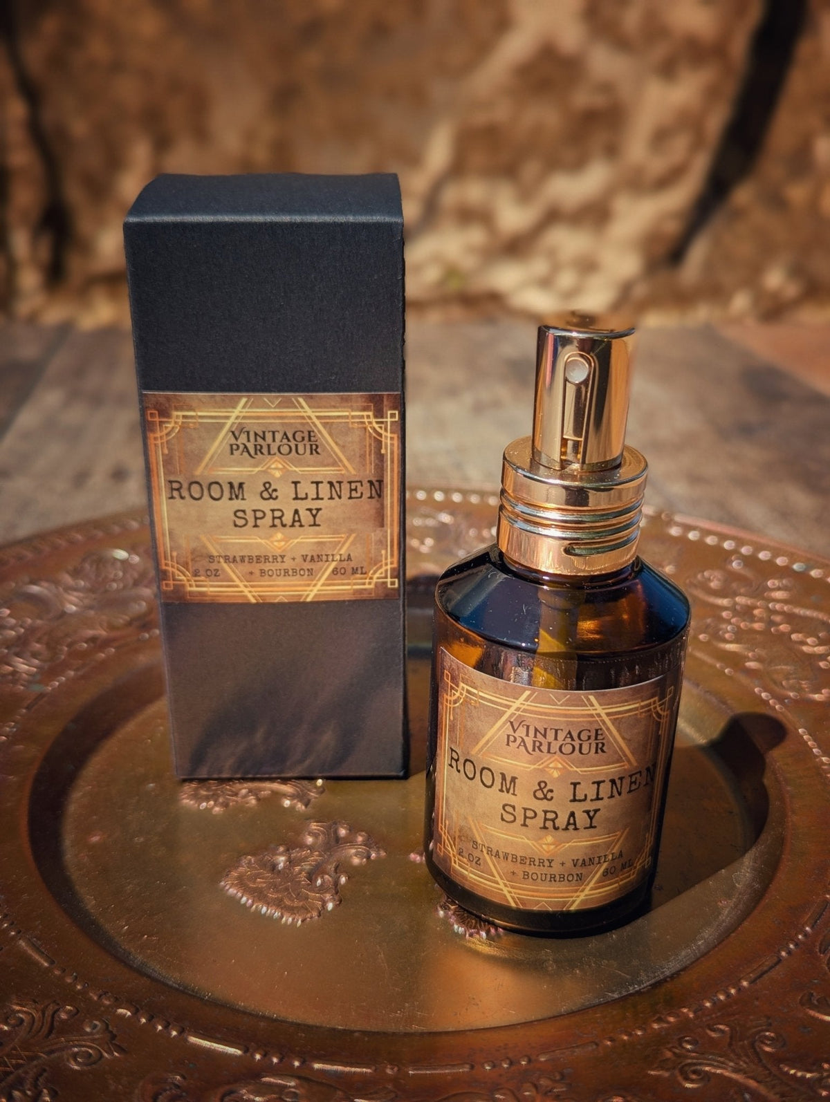 Vintage room and linen spray in amber glass bottle with matching box on an ornate brass tray