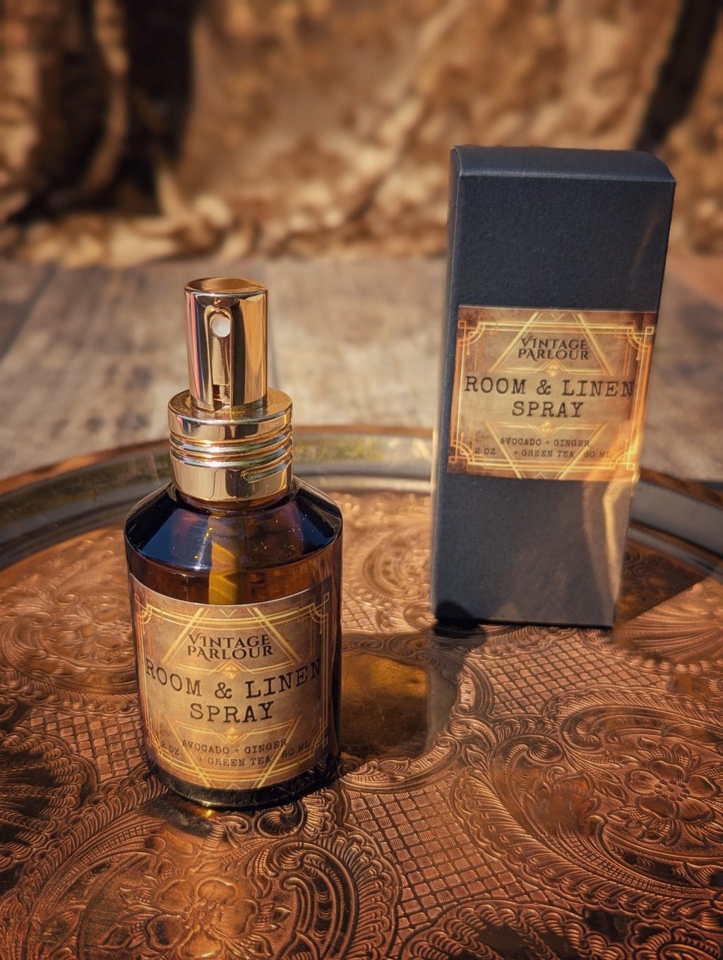 Vintage room and linen spray in amber glass bottle with matching box on an ornate tray